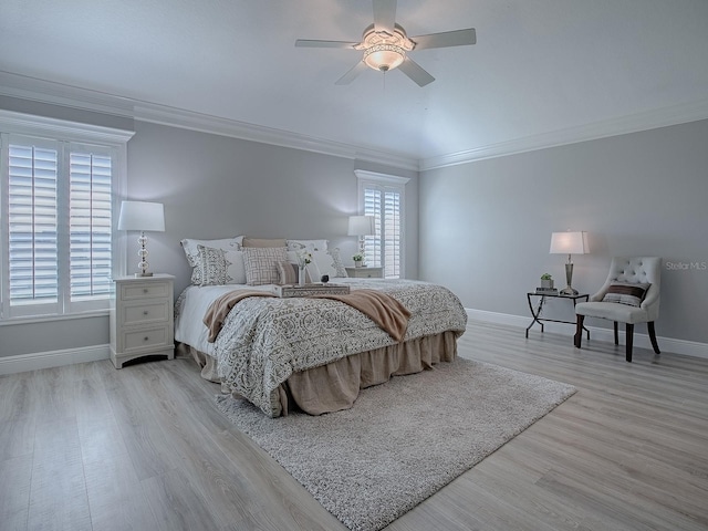 bedroom featuring ornamental molding, light wood-style floors, and baseboards