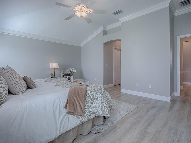 bedroom featuring arched walkways, light wood-style flooring, ornamental molding, and visible vents