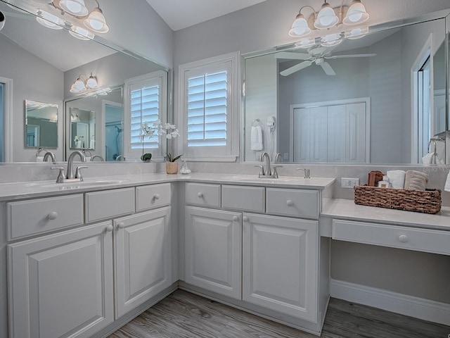 bathroom featuring ceiling fan, double vanity, and a sink