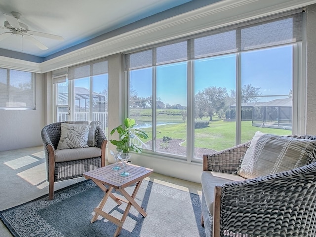 sunroom / solarium featuring a ceiling fan