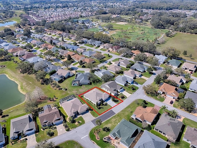 drone / aerial view with a residential view and a water view