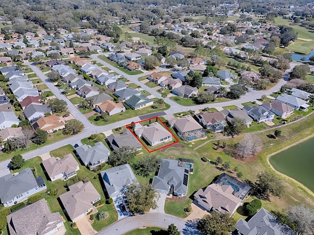 birds eye view of property with a water view and a residential view