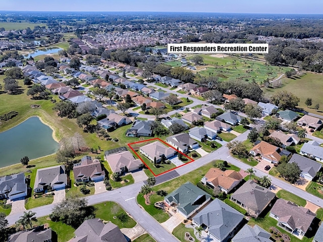 drone / aerial view with a residential view and a water view