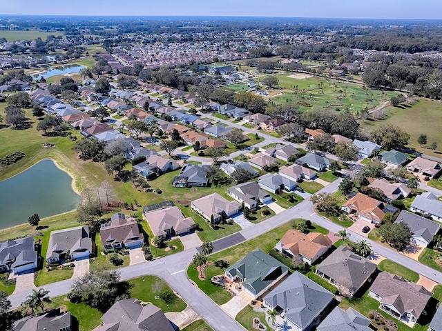 drone / aerial view featuring a residential view and a water view