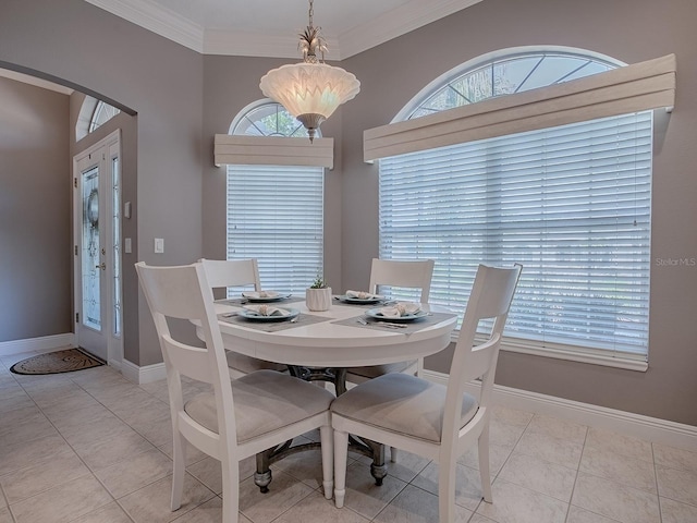 dining room with arched walkways, ornamental molding, light tile patterned floors, and baseboards