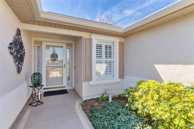 property entrance featuring stucco siding