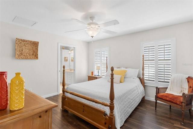 bedroom with dark wood-style floors, ensuite bathroom, a ceiling fan, and baseboards