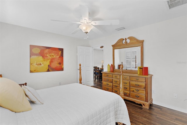 bedroom with dark wood-style floors, visible vents, baseboards, and a ceiling fan