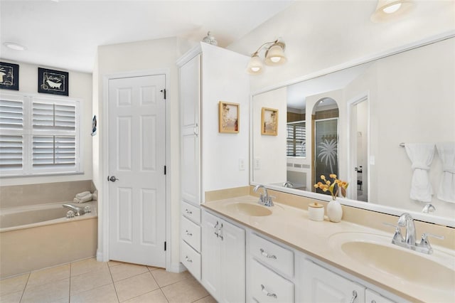 full bathroom featuring double vanity, a stall shower, a sink, and tile patterned floors