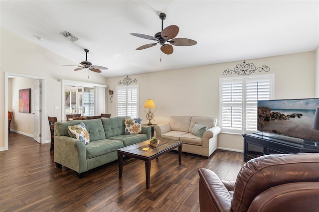 living area with lofted ceiling, dark wood-style flooring, visible vents, and baseboards