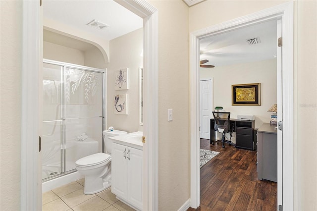 bathroom featuring toilet, a shower stall, visible vents, and vanity