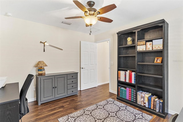 office space with dark wood-style floors, visible vents, ceiling fan, and baseboards