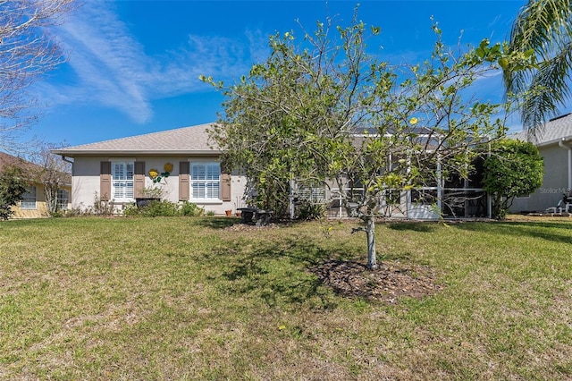 view of front of home with a front lawn and stucco siding