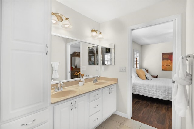 bathroom featuring a sink, double vanity, connected bathroom, and tile patterned floors