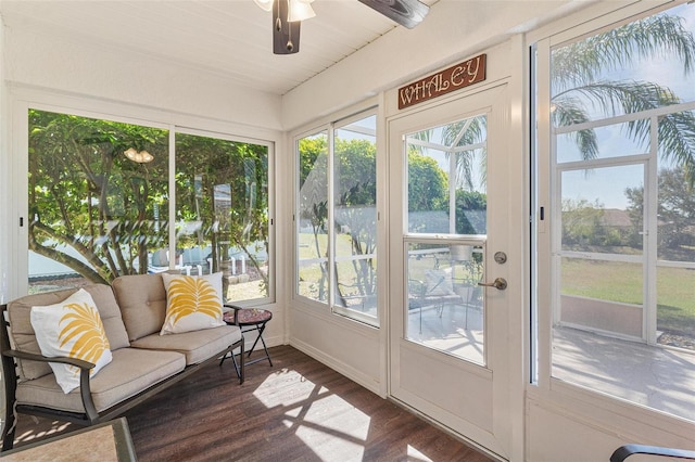 sunroom / solarium featuring baseboards, a wealth of natural light, and wood finished floors