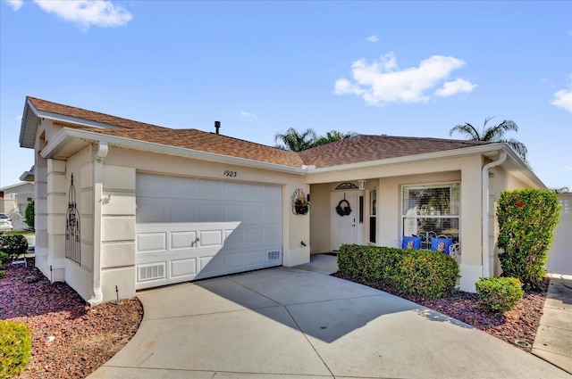 1923 Greeleyville Ter, The Villages, FL 32162 - single story home with an attached garage, roof with shingles, concrete driveway, and stucco siding