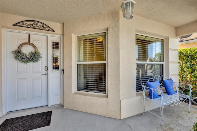 property entrance featuring stucco siding