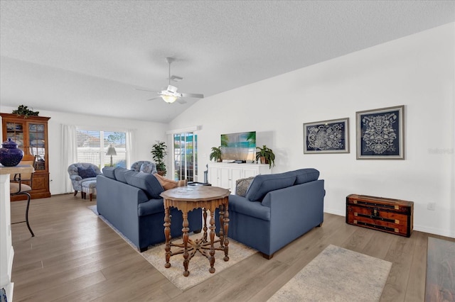 1923 Greeleyville Ter, The Villages, FL 32162 - living room featuring lofted ceiling, ceiling fan, a textured ceiling, visible vents, and light wood finished floors