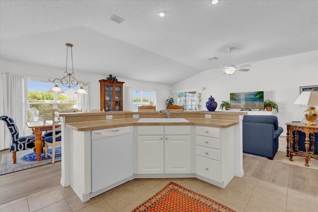 1923 Greeleyville Ter, The Villages, FL 32162 - kitchen featuring open floor plan, white dishwasher, vaulted ceiling, white cabinetry, and a sink
