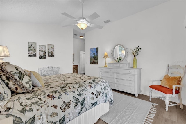 1923 Greeleyville Ter, The Villages, FL 32162 - bedroom featuring lofted ceiling, visible vents, ensuite bathroom, a ceiling fan, and wood finished floors