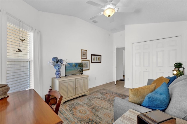 1923 Greeleyville Ter, The Villages, FL 32162 - living area featuring visible vents, a ceiling fan, vaulted ceiling, wood finished floors, and baseboards