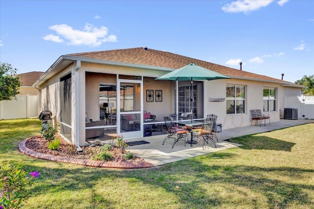 1923 Greeleyville Ter, The Villages, FL 32162 - rear view of property with central air condition unit, fence, a patio, and a lawn