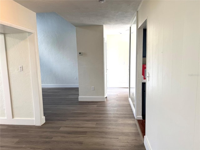 corridor with baseboards and dark wood-style flooring