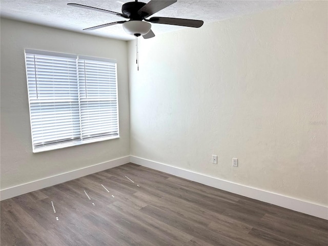 empty room featuring ceiling fan, a textured ceiling, baseboards, and wood finished floors