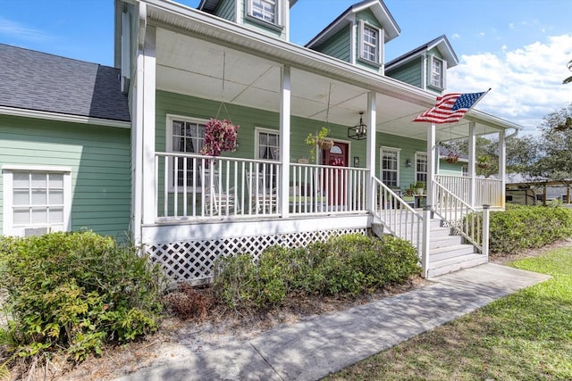 view of front of home with covered porch and roof with shingles