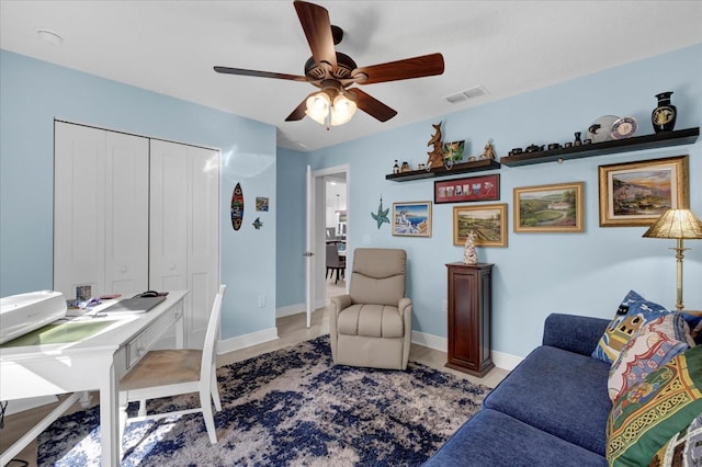 office area with ceiling fan, visible vents, and baseboards