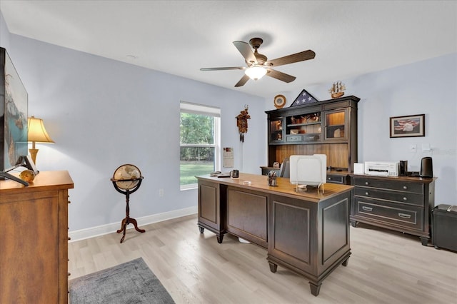 office space featuring light wood-style floors, baseboards, and a ceiling fan