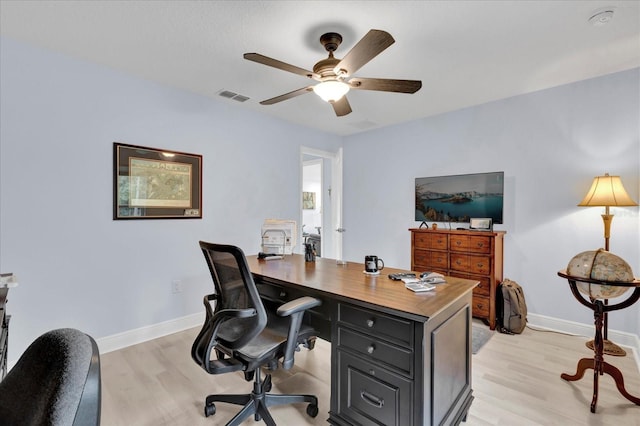 office featuring light wood-style flooring, visible vents, and baseboards