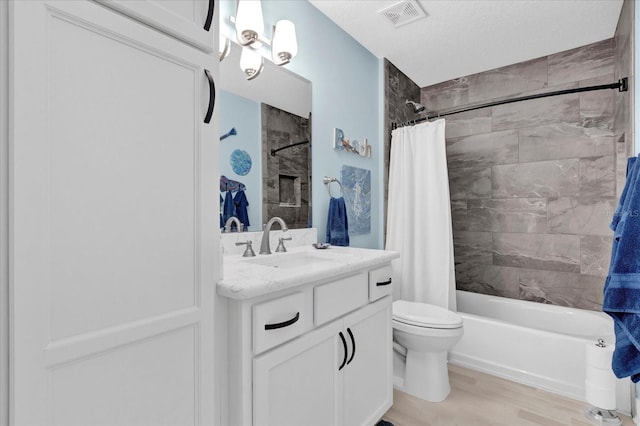 bathroom with visible vents, toilet, wood finished floors, shower / bathtub combination with curtain, and vanity