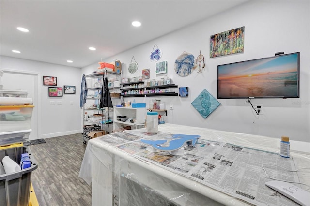 interior space featuring recessed lighting, baseboards, and wood finished floors