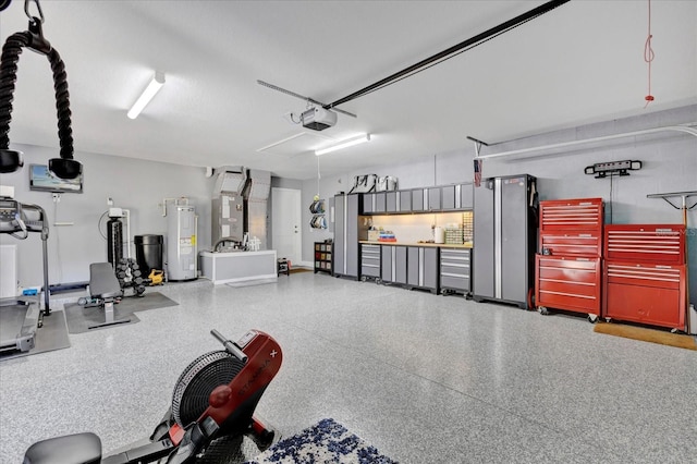 garage with a garage door opener and water heater