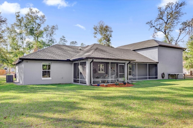 back of house featuring a shingled roof, cooling unit, a sunroom, and a yard