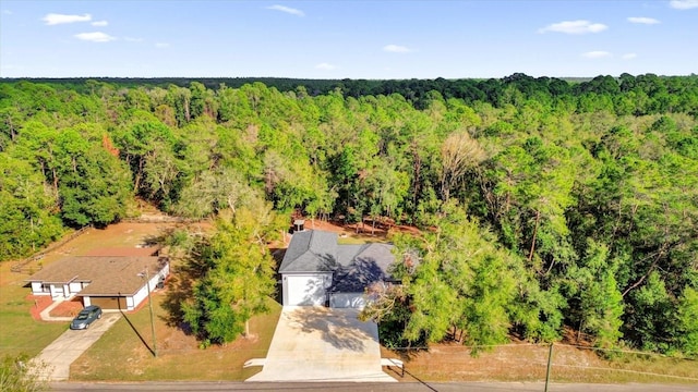 birds eye view of property featuring a wooded view