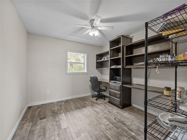 office space featuring wood finished floors, a ceiling fan, and baseboards