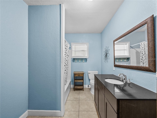 bathroom with baseboards, vanity, toilet, and tile patterned floors