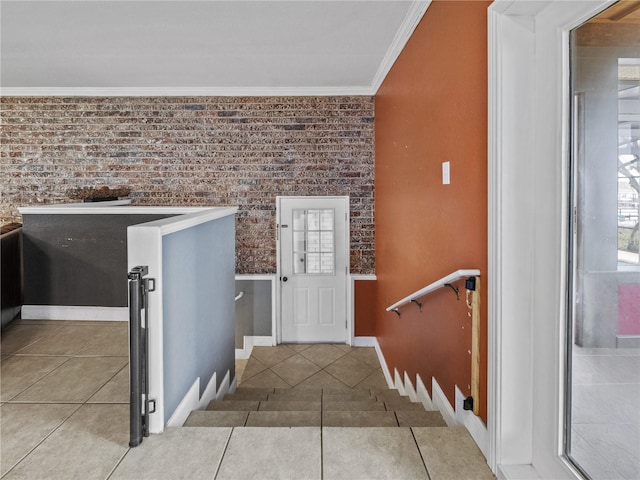 interior space with brick wall, baseboards, and crown molding