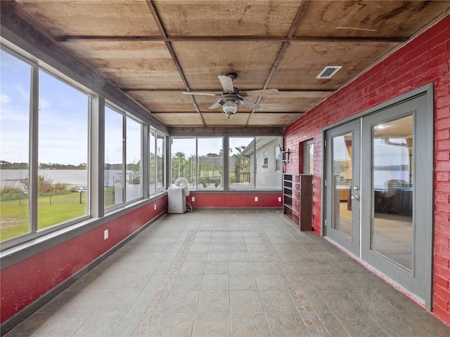 unfurnished sunroom featuring wood ceiling, ceiling fan, visible vents, and french doors