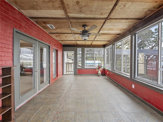 unfurnished sunroom featuring ceiling fan, french doors, wooden ceiling, and visible vents