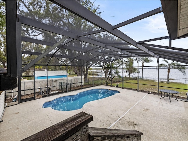 view of swimming pool with glass enclosure, a patio area, fence, and a fenced in pool