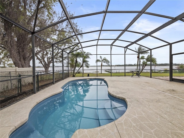 view of swimming pool featuring a fenced in pool, a lanai, a patio area, and fence