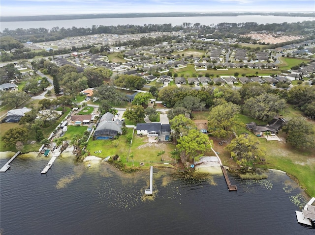 birds eye view of property with a water view and a residential view