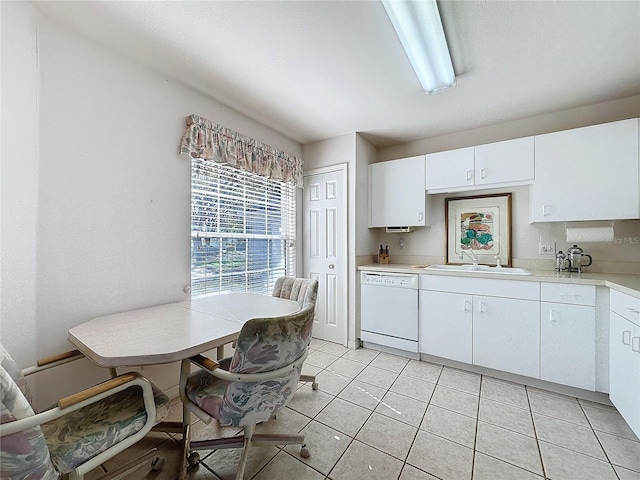 kitchen featuring white cabinets, dishwasher, light countertops, a sink, and light tile patterned flooring