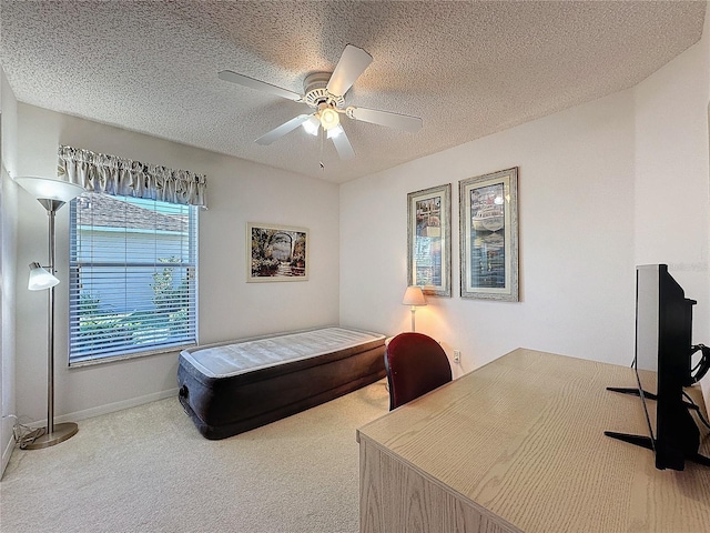 bedroom featuring a textured ceiling, ceiling fan, carpet, and baseboards