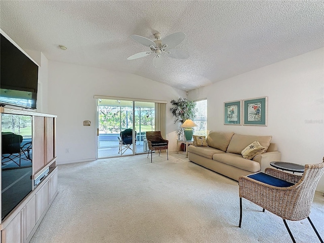 living room featuring vaulted ceiling, ceiling fan, a textured ceiling, and light colored carpet