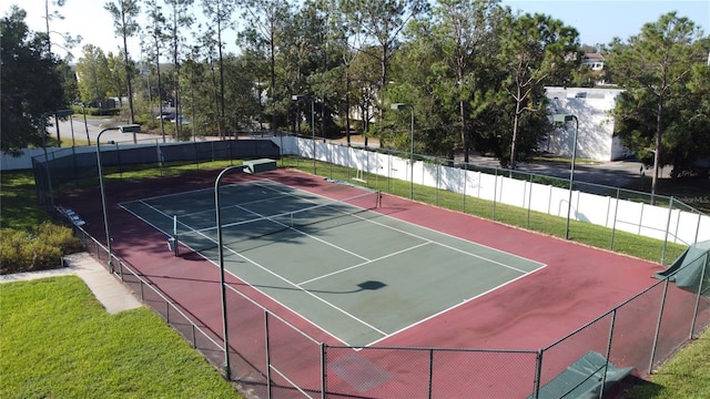 view of sport court with community basketball court, fence, and a lawn