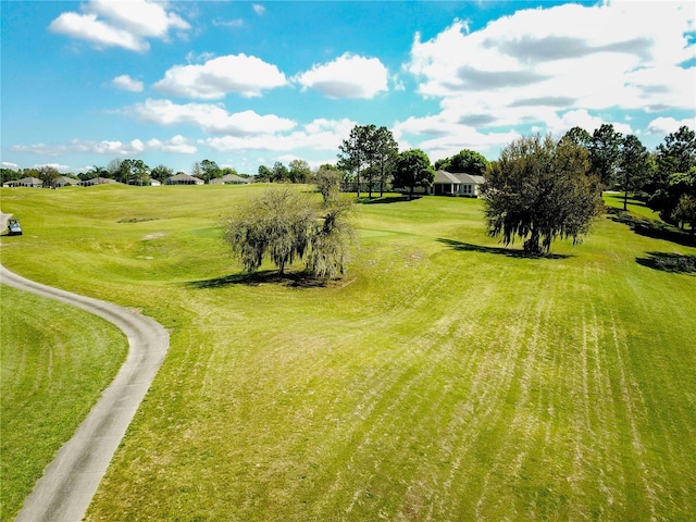 exterior space featuring view of golf course and a yard